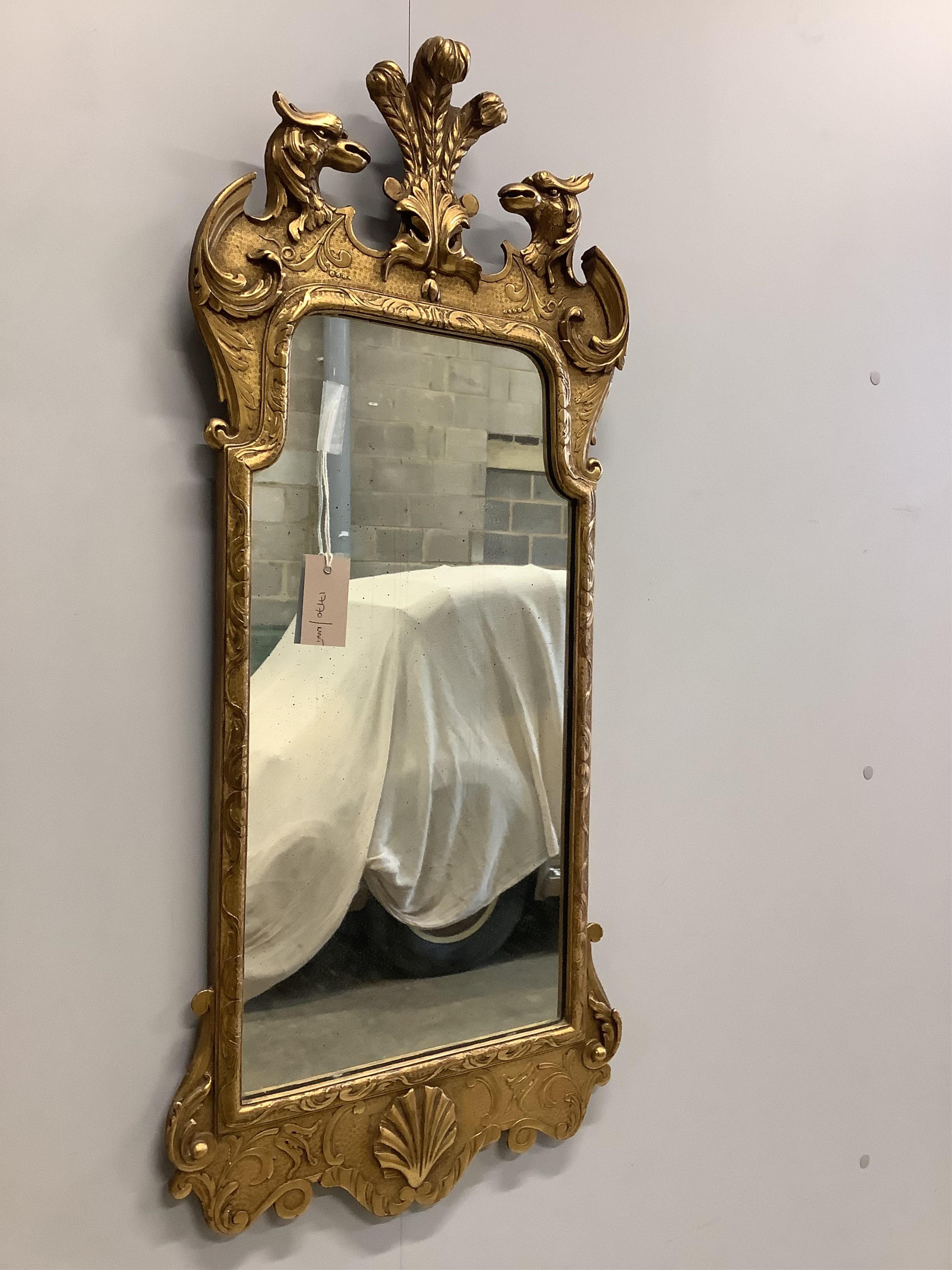 A George II style carved giltwood wall mirror with eagle surmount, width 40cm, 96cm high. Condition - good